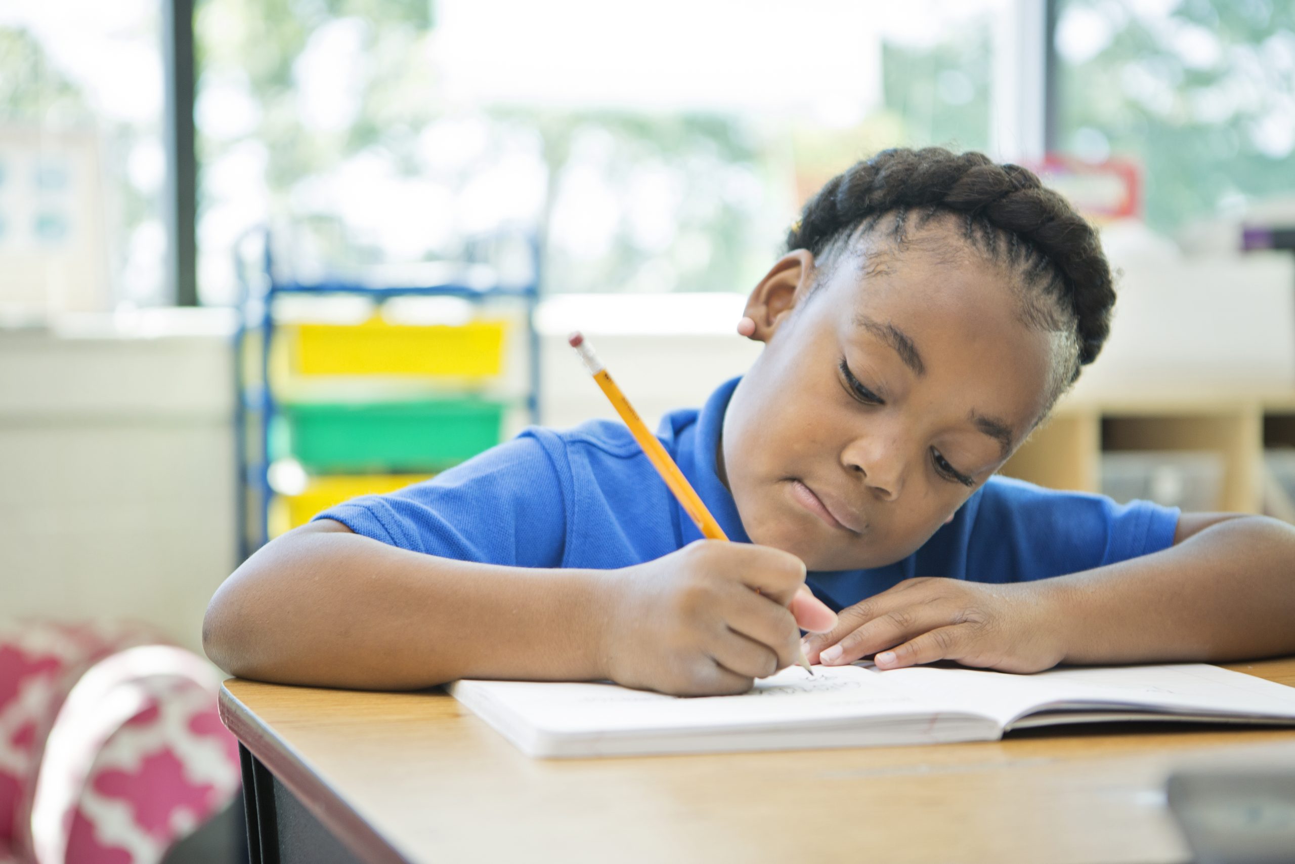 photo of child in school writing in a workbook